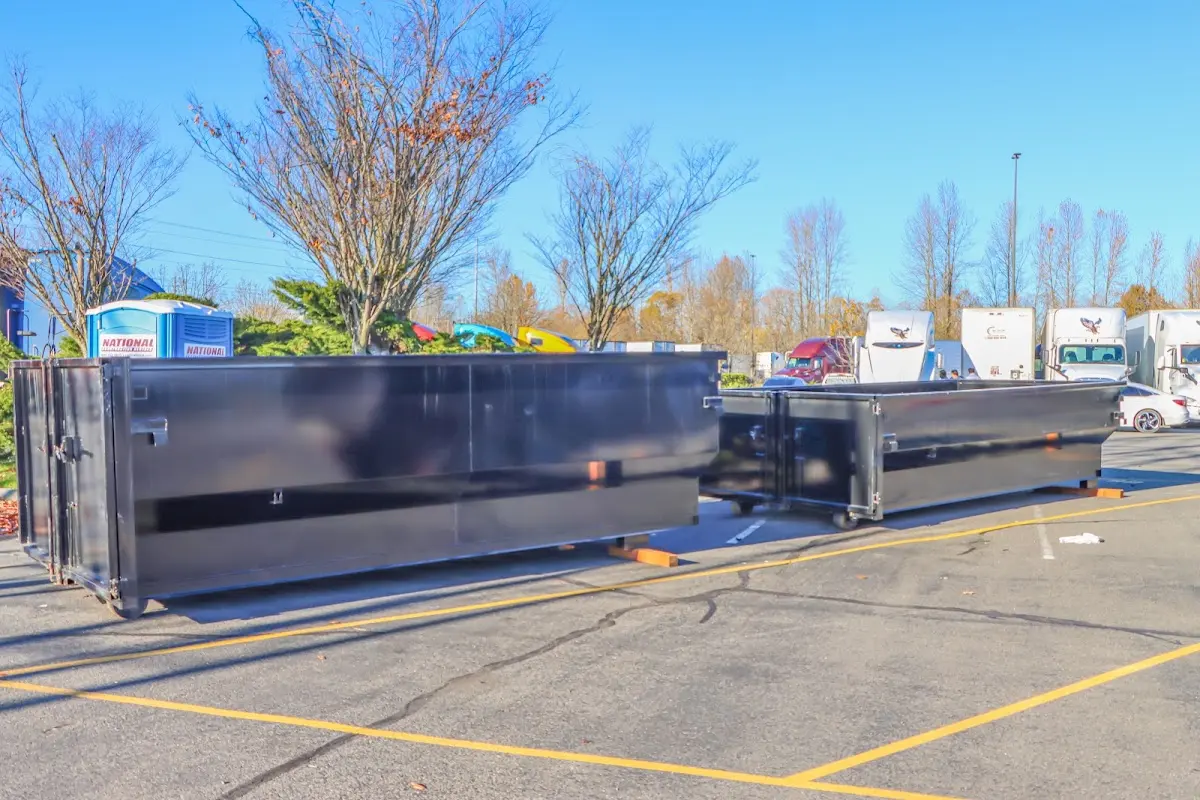 Professional dumpster rental service with roll-off container on residential driveway in Green Brook